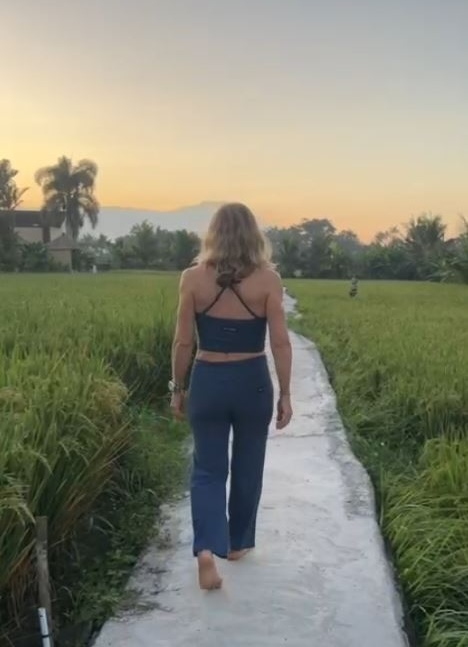 Gia walking along a path at a Bali yoga retreat.